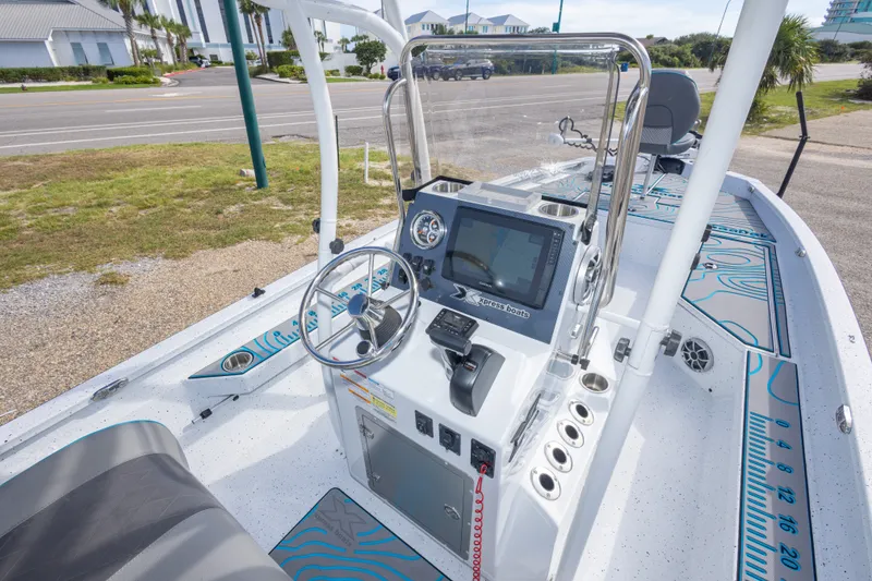 Slide: The Image of 2024 Xpress H22 Bay boat interior with steering console and navigation system. - 25