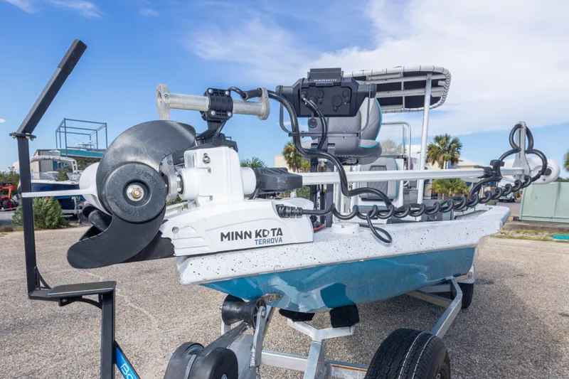 Slide: The Image of 2024 Xpress H22 Bay boat with Minn Kota Terrova motor, parked outdoors. - 20