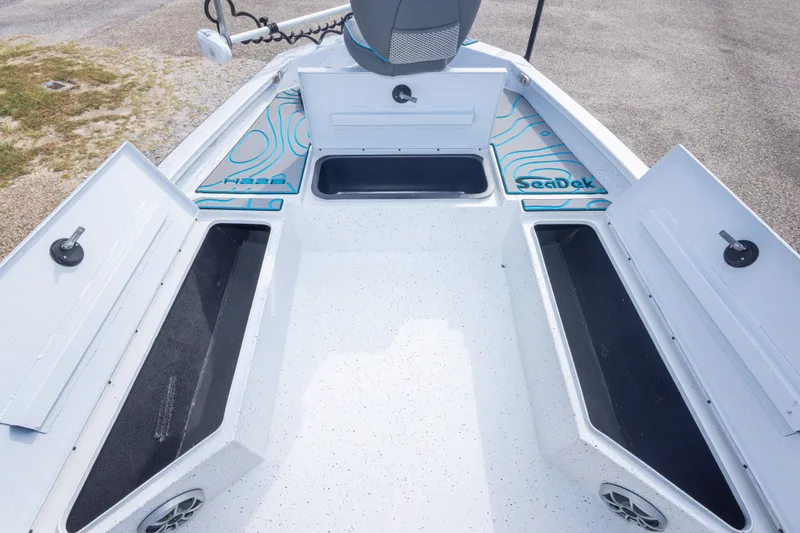 Slide: The Image of 2024 Xpress H22 Bay boat interior with open storage compartments and SeaDek flooring. - 35