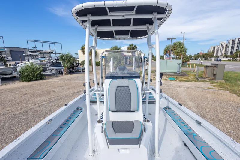 Slide: The Image of 2024 Xpress H22 Bay boat with T-top and seating, parked outdoors. - 48