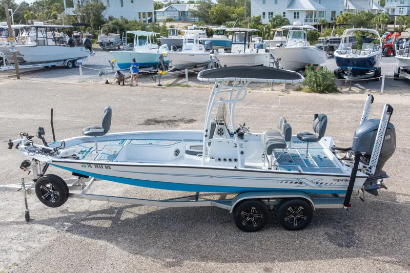 Slide: The Image of 2024 Xpress H22 Bay boat on trailer in marina setting. - 3