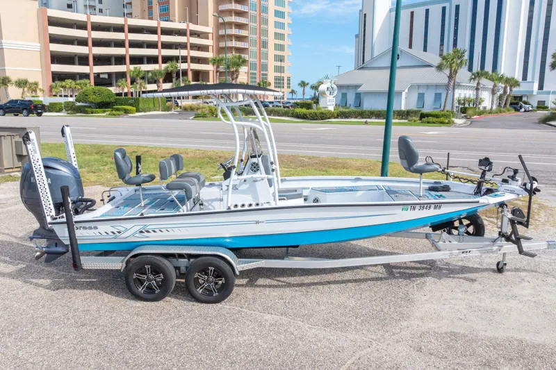 Slide: The Image of 2024 Xpress H22 Bay boat on trailer, parked near urban buildings. - 1