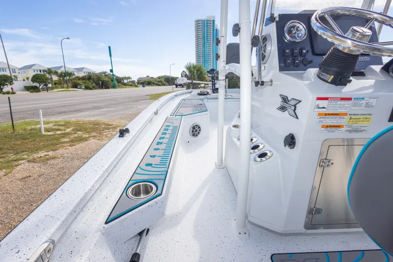 Slide: The Image of 2024 Xpress H22 Bay boat interior with steering console and measurement markings. - 46