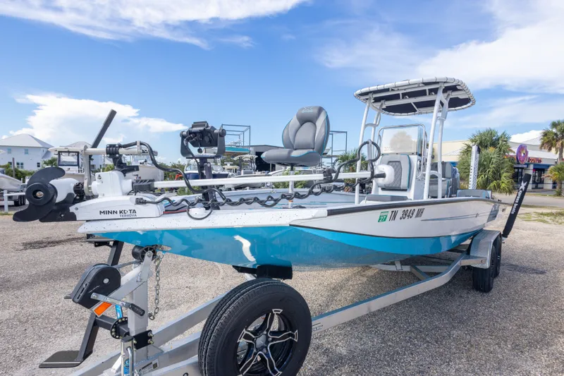 Slide: The Image of 2024 Xpress H22 Bay boat on trailer, featuring Minn Kota Terrova motor. - 19