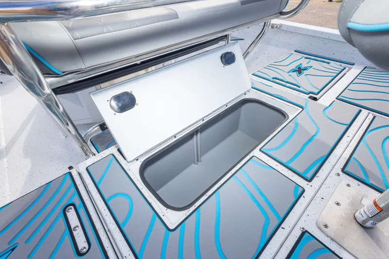 Slide: The Image of 2024 Xpress H22 Bay boat storage compartment with stylish blue and gray design. - 45