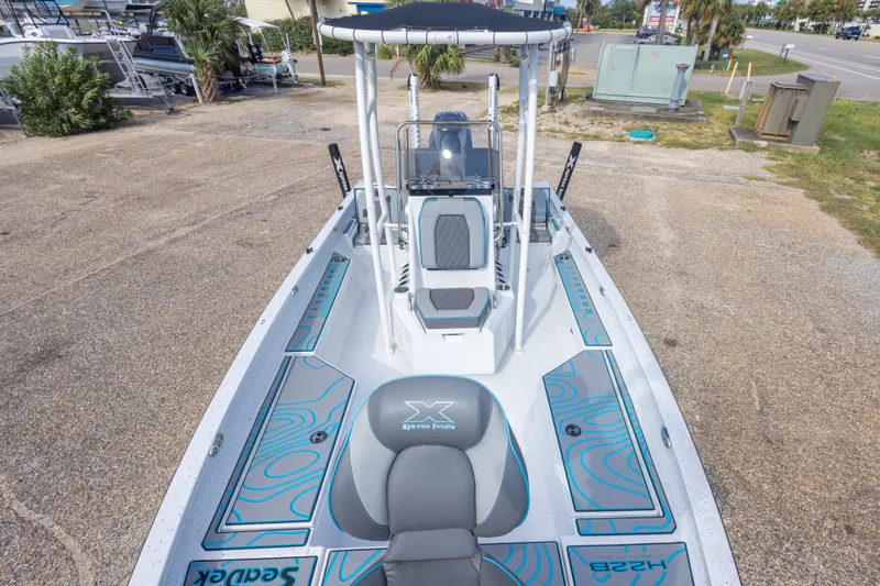 Slide: The Image of 2024 Xpress H22 Bay boat with sleek design and modern features, parked outdoors. - 32