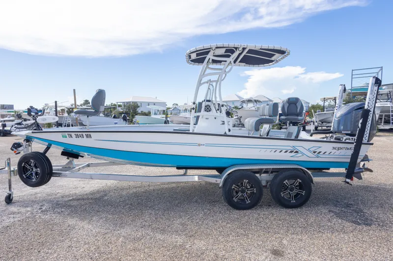 Slide: The Image of 2024 Xpress H22 Bay boat on trailer, featuring sleek design and modern amenities. - 18