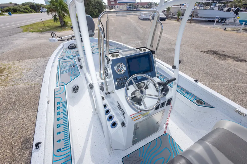 Slide: The Image of 2024 Xpress H22 Bay boat interior with steering console and modern navigation equipment. - 24