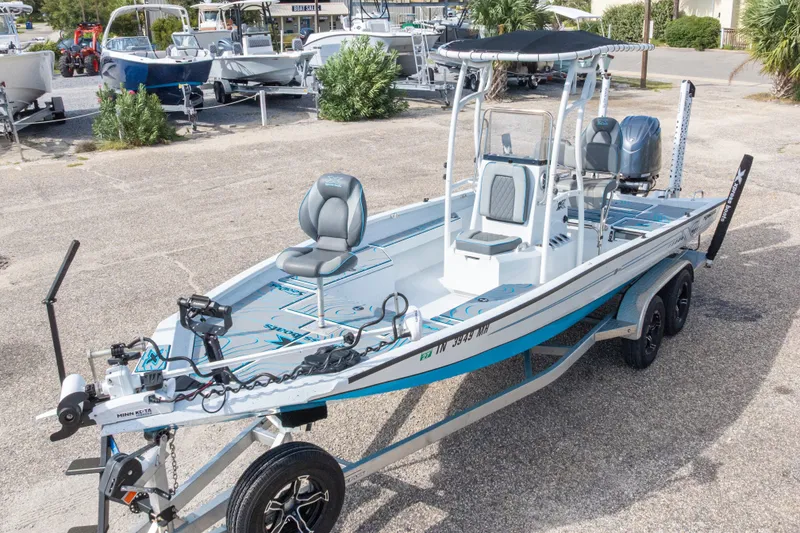 Slide: The Image of 2024 Xpress H22 Bay boat on trailer, featuring modern design and seating. - 4