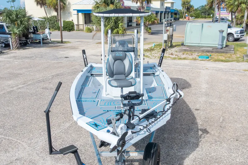 Slide: The Image of 2024 Xpress H22 Bay boat on trailer, featuring advanced navigation equipment and sleek design. - 5
