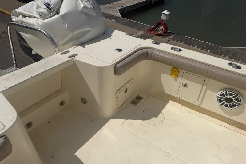 Slide: The Image of 2006 World Cat 270 TE boat interior with seating and storage compartments at dock. - 15