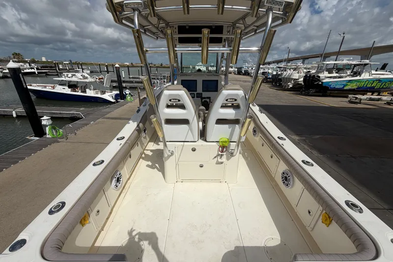 Slide: The Image of 2006 World Cat 270 TE boat interior at marina, showcasing seating and controls. - 12