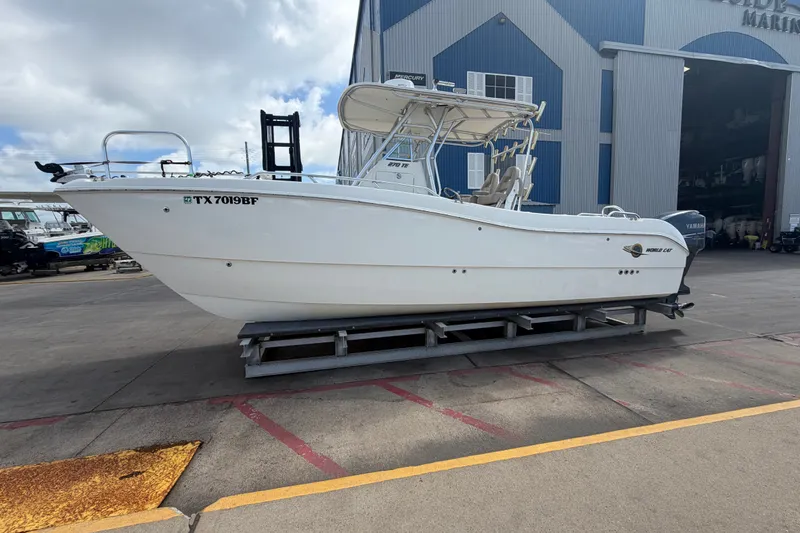 Slide: The Image of 2006 World Cat 270 TE boat on trailer outside a marina building. - 6