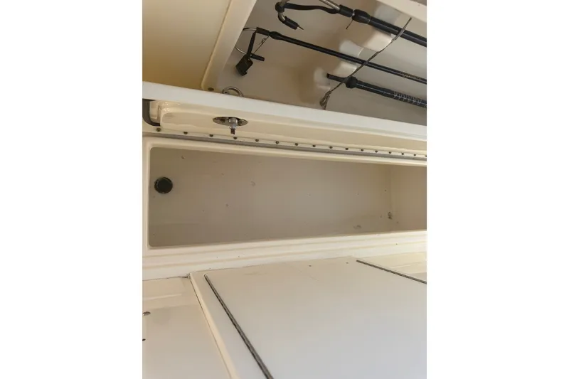 Slide: The Image of Storage compartment on a 2006 World Cat 270 TE boat, featuring fishing rod holders. - 25