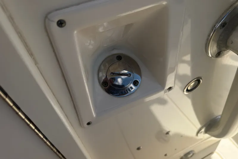 Slide: The Image of Close-up of a 2006 World Cat 270 TE freshwater fill cap on a boat. - 26