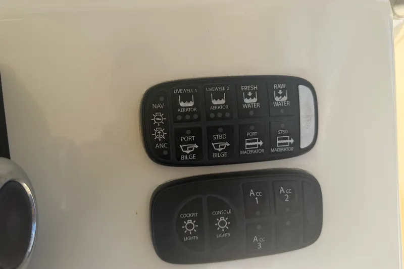 Slide: The Image of Control panel of a 2006 World Cat 270 TE boat with various switches. - 34