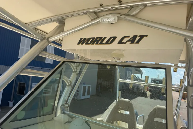 Slide: The Image of 2006 World Cat 270 TE boat with windshield and metal frame, docked outdoors. - 51
