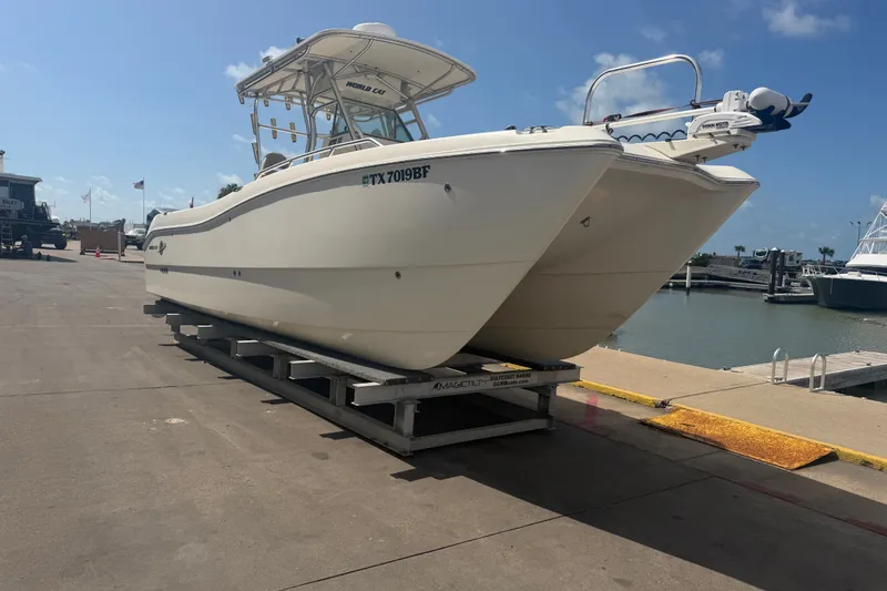 Slide: The Image of 2006 World Cat 270 TE boat on dock, sunny marina background. - 3