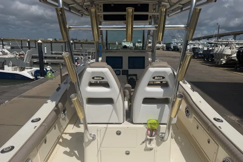 Slide: The Image of 2006 World Cat 270 TE boat interior with dual seats and rod holders at marina. - 7