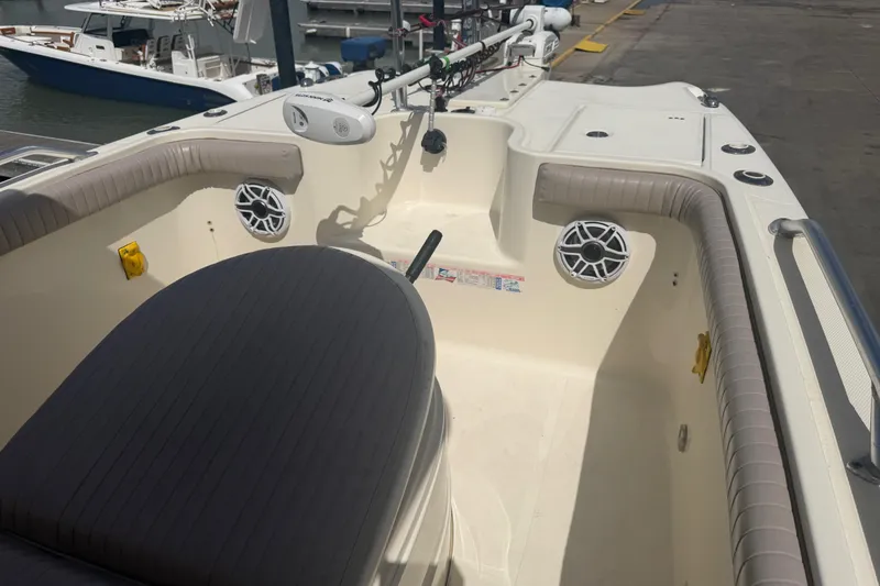 Slide: The Image of 2006 World Cat 270 TE boat interior with seating and speakers at a marina. - 18