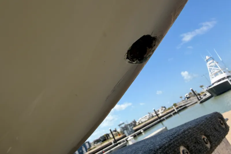 Slide: The Image of Damaged hull of 2006 World Cat 270 TE boat at marina. - 54