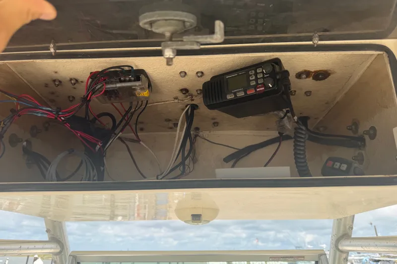Slide: The Image of Open electronics compartment of 2006 World Cat 270 TE boat, showing wiring and radio equipment. - 37