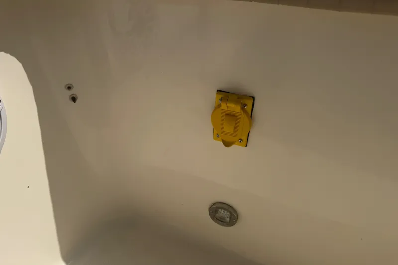 Slide: The Image of 2006 World Cat 270 TE boat interior with yellow electrical outlet and light fixture. - 46