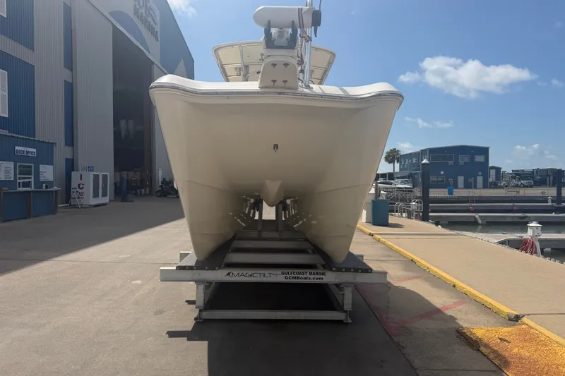 Slide: The Image of 2006 World Cat 270 TE boat on trailer at marina under clear blue sky. - 4