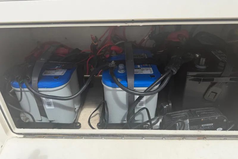 Slide: The Image of Battery compartment of a 2006 World Cat 270 TE boat, featuring multiple batteries. - 45