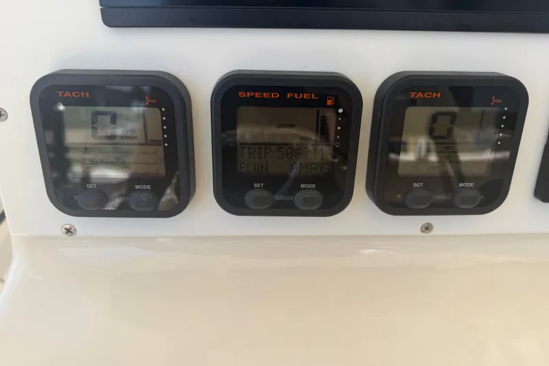 Slide: The Image of Dashboard of a 2006 World Cat 270 TE boat with tachometer and fuel gauges. - 28