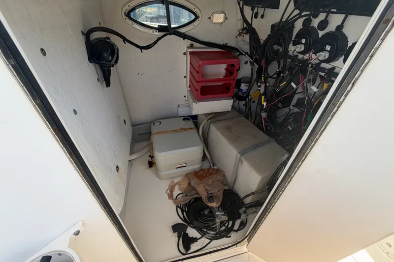 Slide: The Image of Interior of a 2006 World Cat 270 TE boat showing storage and wiring. - 23