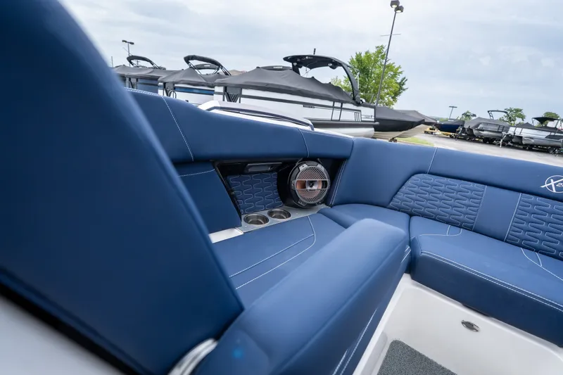 Slide: The Image of 2021 MasterCraft X24 boat interior with blue seating and speaker system. - 35