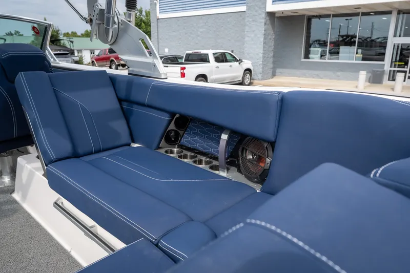 Slide: The Image of 2021 MasterCraft X24 boat interior with blue seating and speaker system. - 25