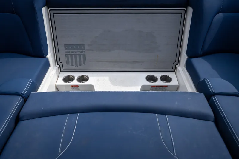 Slide: The Image of Interior of 2021 MasterCraft X24 boat with blue seating and cup holders. - 48