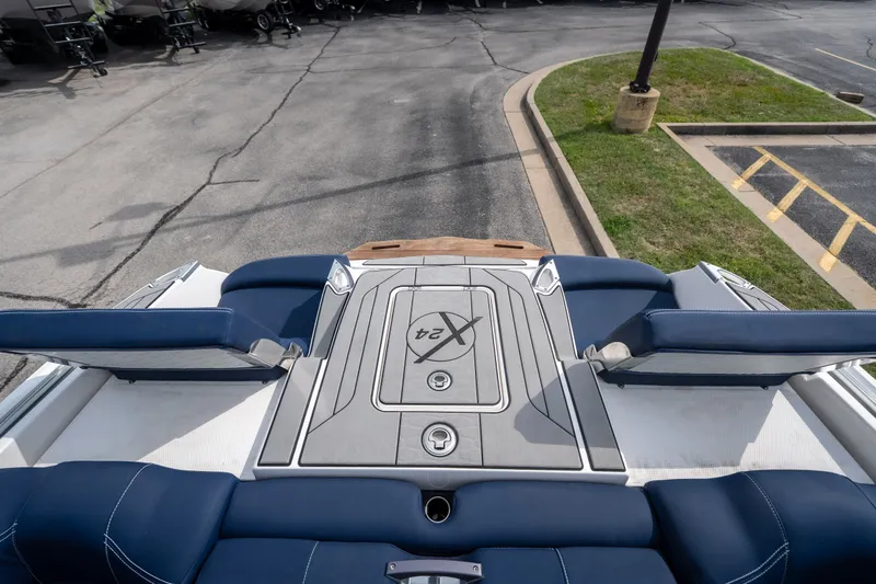 Slide: The Image of 2021 MasterCraft X24 boat interior with blue seating and sleek design. - 55