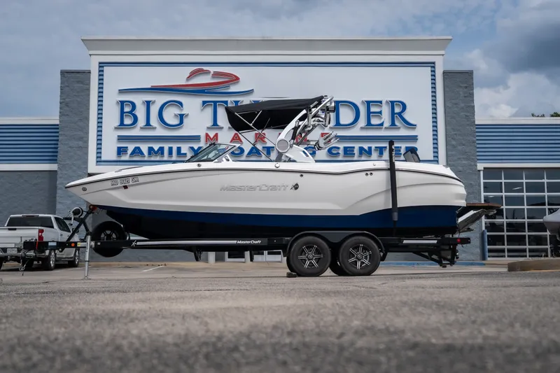 The Image of 2021 MasterCraft X24 boat on trailer at Big Thunder Marine dealership. - 1