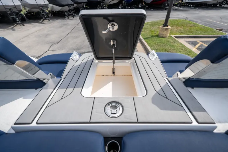 Slide: The Image of 2021 MasterCraft X24 boat storage compartment open, showcasing sleek design and functionality. - 49