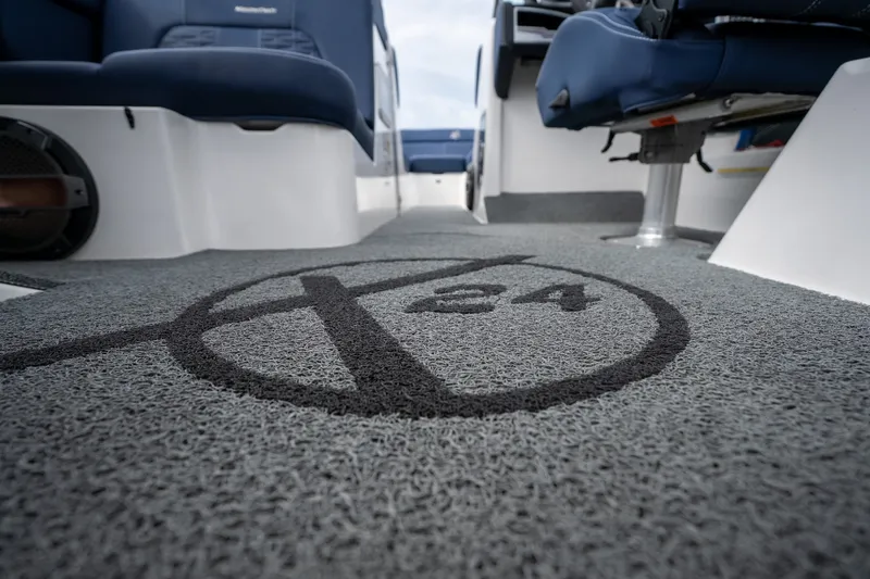 Slide: The Image of 2021 MasterCraft X24 boat interior with logo on textured flooring. - 32