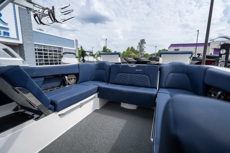 Slide: The Image of 2021 MasterCraft X24 boat interior with blue seating and modern design. - 31