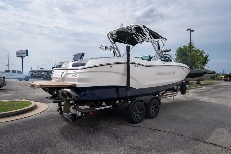 Slide: The Image of 2021 MasterCraft X24 boat on trailer in parking lot, ready for transport. - 3