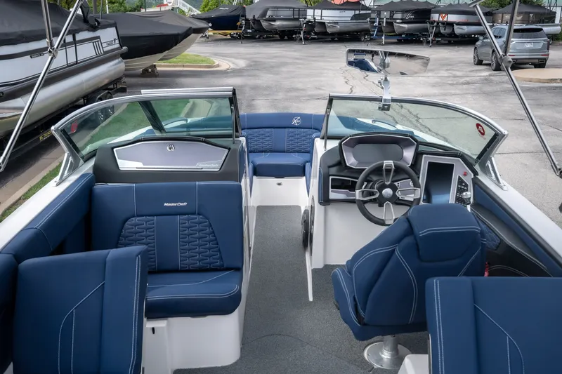 Slide: The Image of 2021 MasterCraft X24 boat interior with blue seating and modern dashboard design. - 26