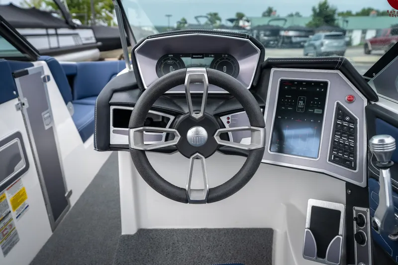 Slide: The Image of 2021 MasterCraft X24 boat dashboard with steering wheel and digital controls. - 28