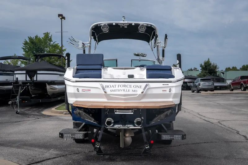 Slide: The Image of 2021 MasterCraft X24 boat, rear view, parked in a lot, labeled "Boat Force One." - 4