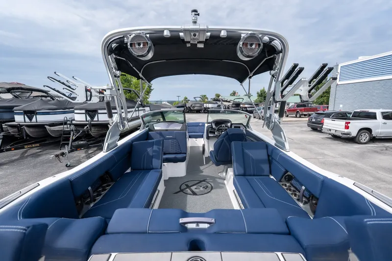 Slide: The Image of 2021 MasterCraft X24 boat interior with blue seating and modern design. - 23