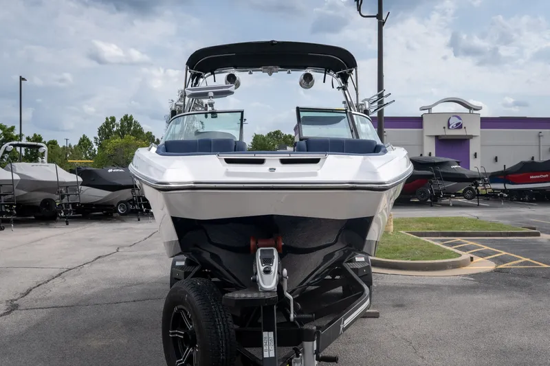 Slide: The Image of 2021 MasterCraft X24 boat on trailer in dealership parking lot. - 10
