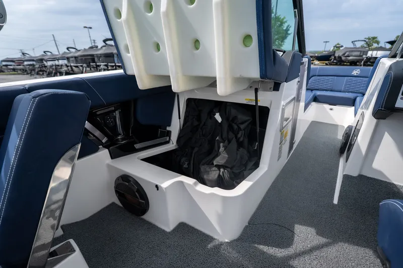 Slide: The Image of 2021 MasterCraft X24 boat interior with open storage compartment and blue seating. - 43