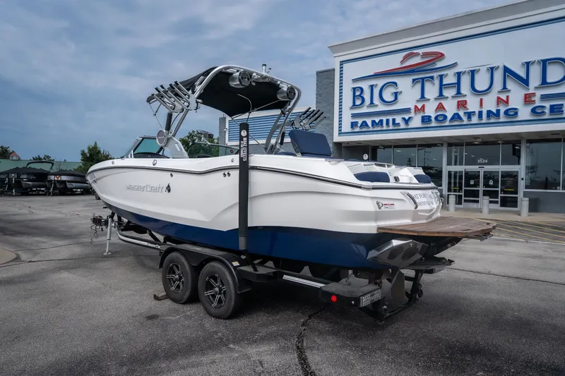 Slide: The Image of 2021 MasterCraft X24 boat on trailer at Big Thunder Marine dealership. - 6