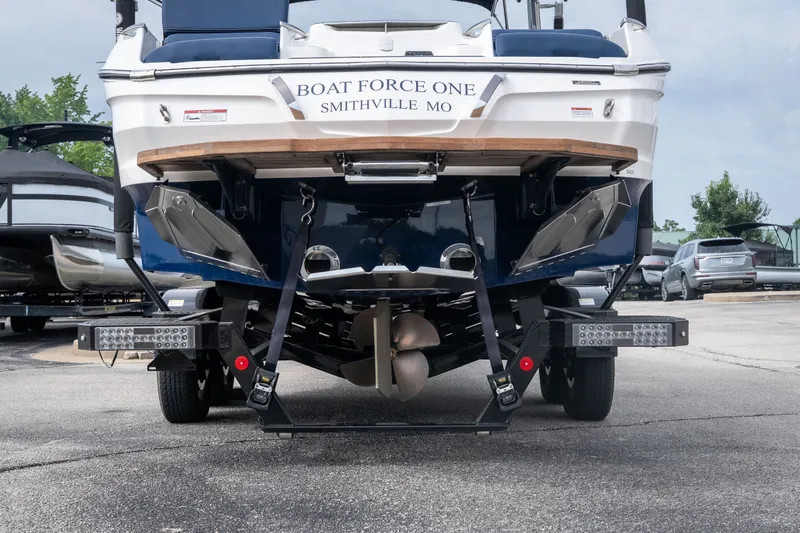 Slide: The Image of 2021 MasterCraft X24 boat on trailer, rear view, labeled "Boat Force One," Smithville, MO. - 5