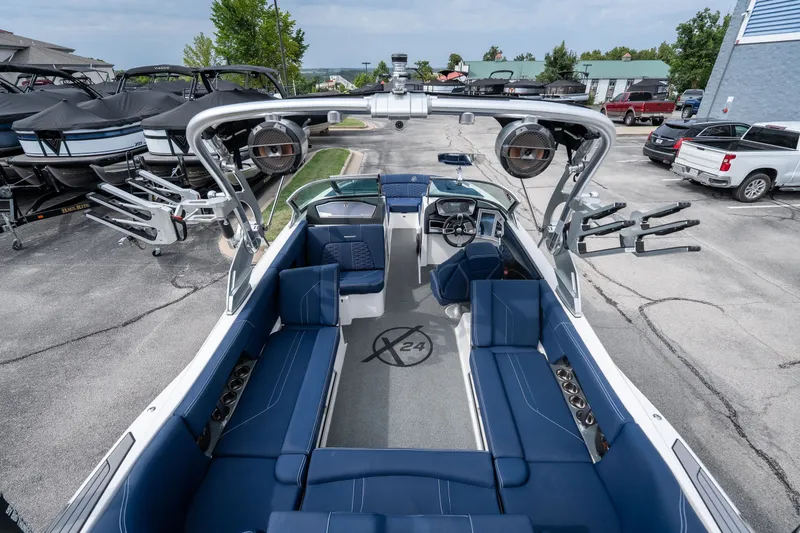 Slide: The Image of 2021 MasterCraft X24 boat interior with blue seating and advanced audio system. - 56