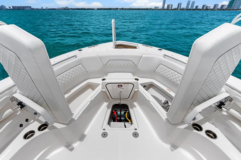 Slide: The Image of 2025 Pursuit S 328 Sport boat interior with luxurious seating and ocean view. - 16